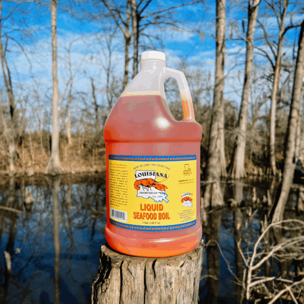 Seafood Boil 1 gallon (1) A gallon jug of LA Crawfish Co. Seafood Boil Liquid rests on a tree stump in a swampy forest.