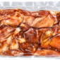 Two pounds of seasoned, marinated bone-in alligator legs, vacuum-sealed in a plastic bag.