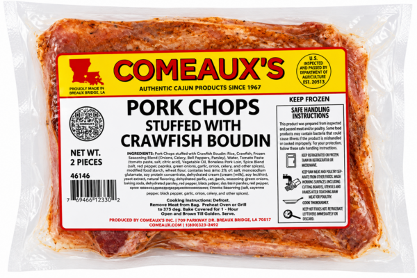 Two raw Comeaux’s crawfish boudin-stuffed pork chops in vacuum-sealed packaging with a product label.
