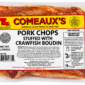 Two raw Comeaux’s crawfish boudin-stuffed pork chops in vacuum-sealed packaging with a product label.