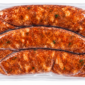 Three vacuum-sealed links of Comeaux’s seasoned fresh chicken sausage.