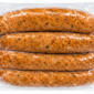 Four vacuum-sealed links of Comeaux’s Extra Hot Pork Boudin in clear plastic.