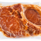 A vacuum-sealed, raw bone-in Comeaux’s pork chop stuffed with seasoned pork sausage.