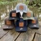 Six multi-colored LA Crawfish Co. hats, each featuring a leather patch with a crawfish logo.
