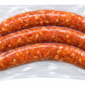 Three raw, seasoned Poche’s Smoked Alligator & Pork sausages in clear vacuum-sealed plastic packaging.
