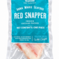 Two vacuum-packed Anna Marie Red Snapper fillets in plastic packaging with a blue product label.