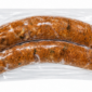 Two vacuum-sealed links of The Best Stop Original Boudin in clear plastic packaging.