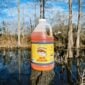 A half-gallon plastic jug of orange LA Crawfish Co. Seafood Boil liquid concentrate.