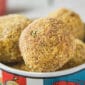 A vibrant dish displays golden-brown, breadcrumb-coated La Boucherie Boudin Balls ready to be served.