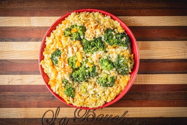 La Boucherie 1 lb Broccoli and Rice Side Dish, ideal with Louisiana seafood or Cajun meats, served in a red bowl.
