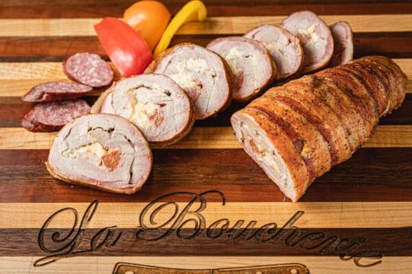 Stuffed pork tenderloin with shrimp, andouille, and pepper jack, served with tomatoes and peppers for a Louisiana touch.