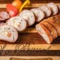 Stuffed pork tenderloin with shrimp, andouille, and pepper jack, served with tomatoes and peppers for a Louisiana touch.