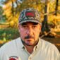 A man wears a matching shirt and an LA Crawfish Co. Coastland PVC patch hat featuring a red crawfish.