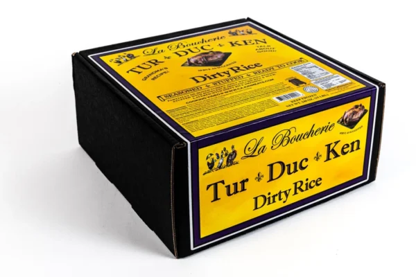 dirty rice box A 15 lb La Boucherie Turducken with dirty rice in a black box, featuring yellow and purple labels.