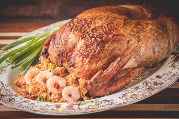 15lb_shr_saus_jamb__24762.1760541128.1280.1280.jpg A 15 lb La Boucherie Turducken served on a platter with stuffing, shrimp, green onions, and Louisiana seafood flavors.
