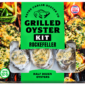 Packaging for a 1/2 dozen Rockefeller Grilled Oyster Kit, featuring a green background and flame imagery.
