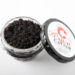 An open jar of Cajun Caviar Spicy, inspired by Louisiana seafood, rests on a plain white background.