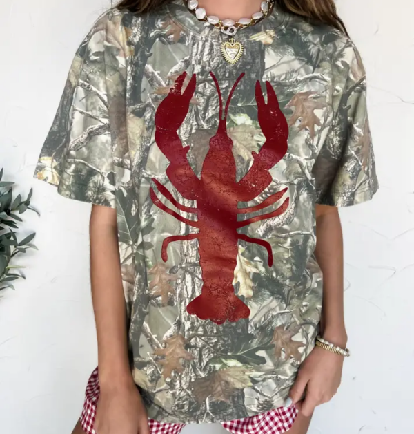 Camo Crawfish T-shirt for Cajun food fans, styled with checkered shorts and gold jewelry for bold Southern flair.