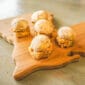 Five snacks from The Snack Sampler (Staff Faves) are arranged on a Texas-shaped board, ideal alongside Cajun or Louisiana crawfish dishes.