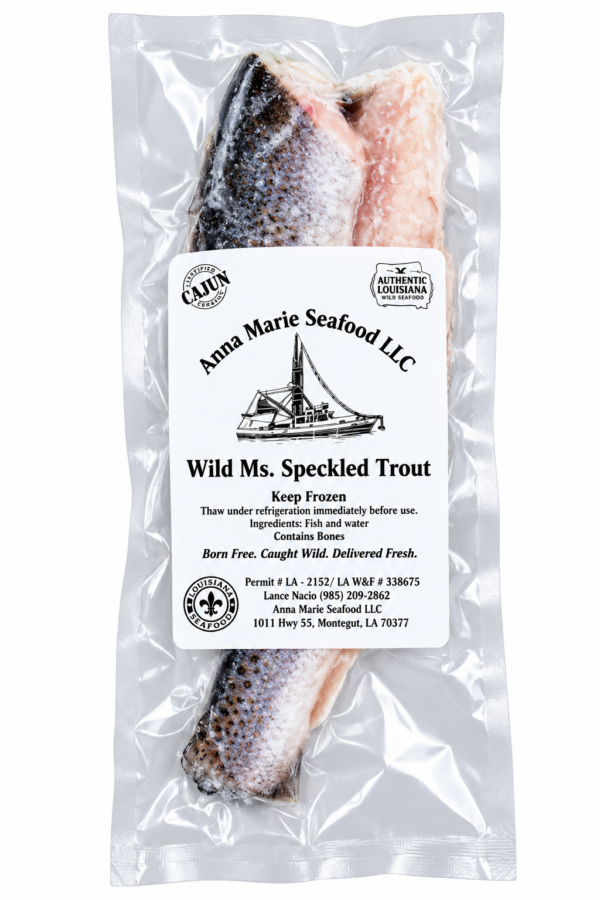 A vacuum-sealed filet of Anna Marie speckled trout in a clear plastic bag with a product label.
