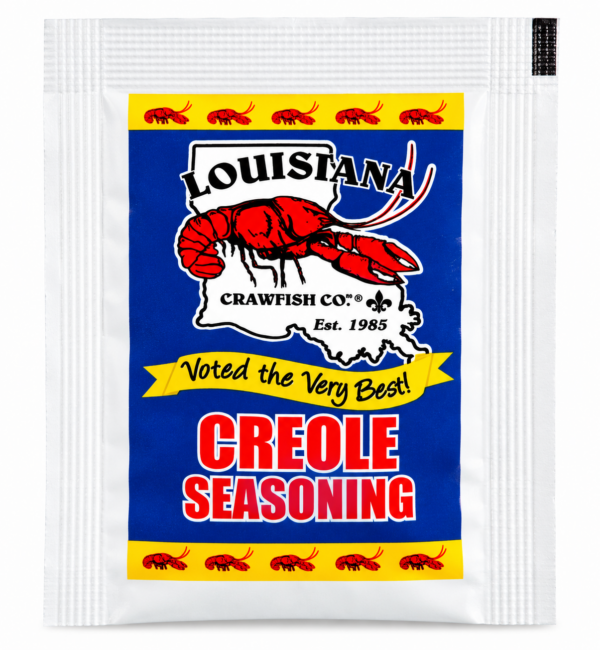 Packet of LA Crawfish Co Creole Seasoning featuring crawfish art, a Louisiana outline, and a bold red, blue, and yellow design.